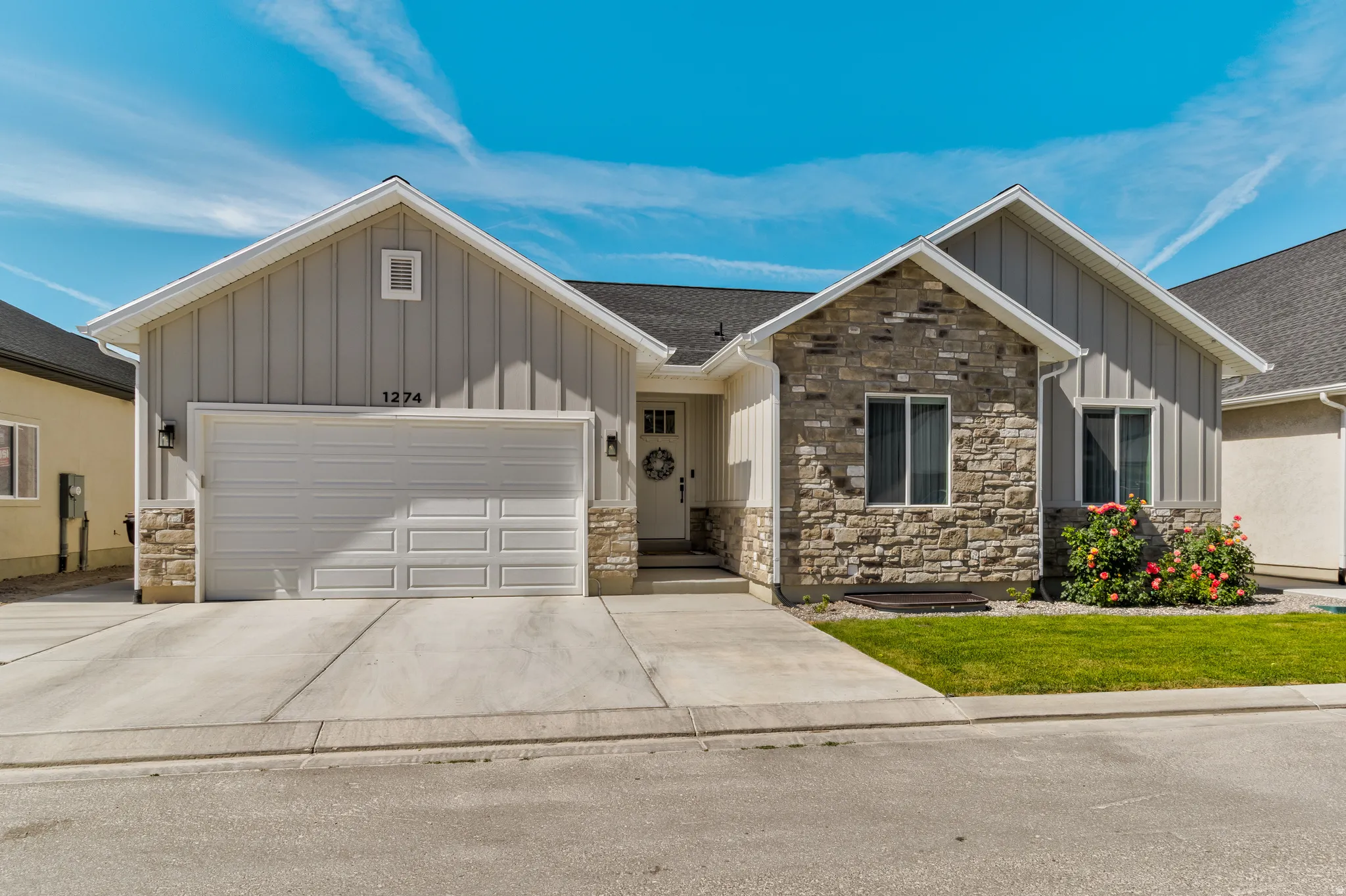 Contemporary exterior featuring board and batten siding and stone accents