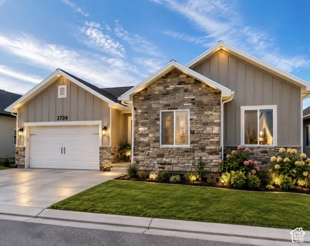 Stone and board-and-batten exterior with an attached two-car garage