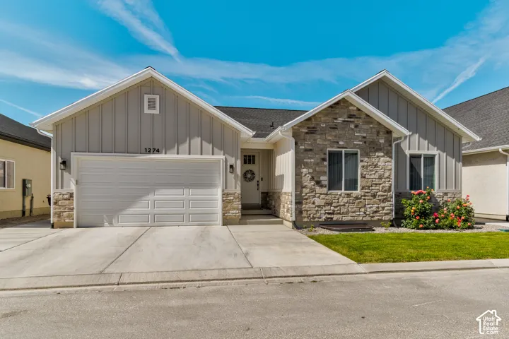 Contemporary exterior featuring board and batten siding and stone accents
