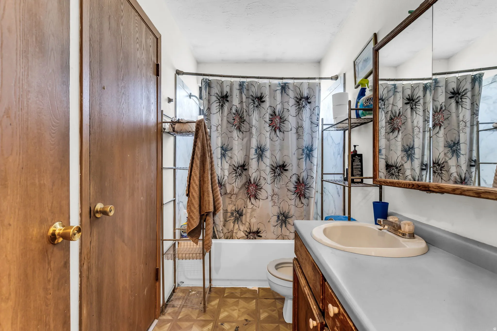 Bathroom featuring a white bathtub, toilet, and a vanity with an integrated sink