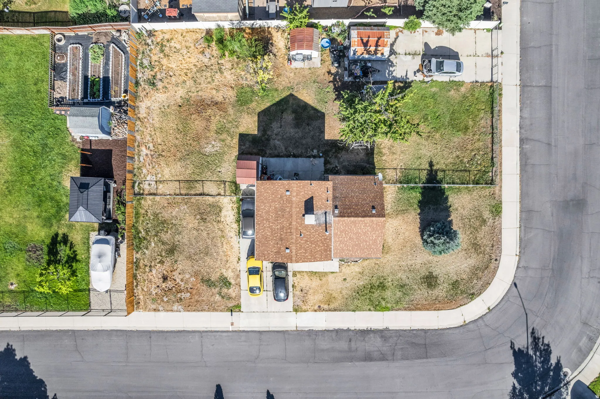 Aerial perspective showcasing a corner lot with a residential structure