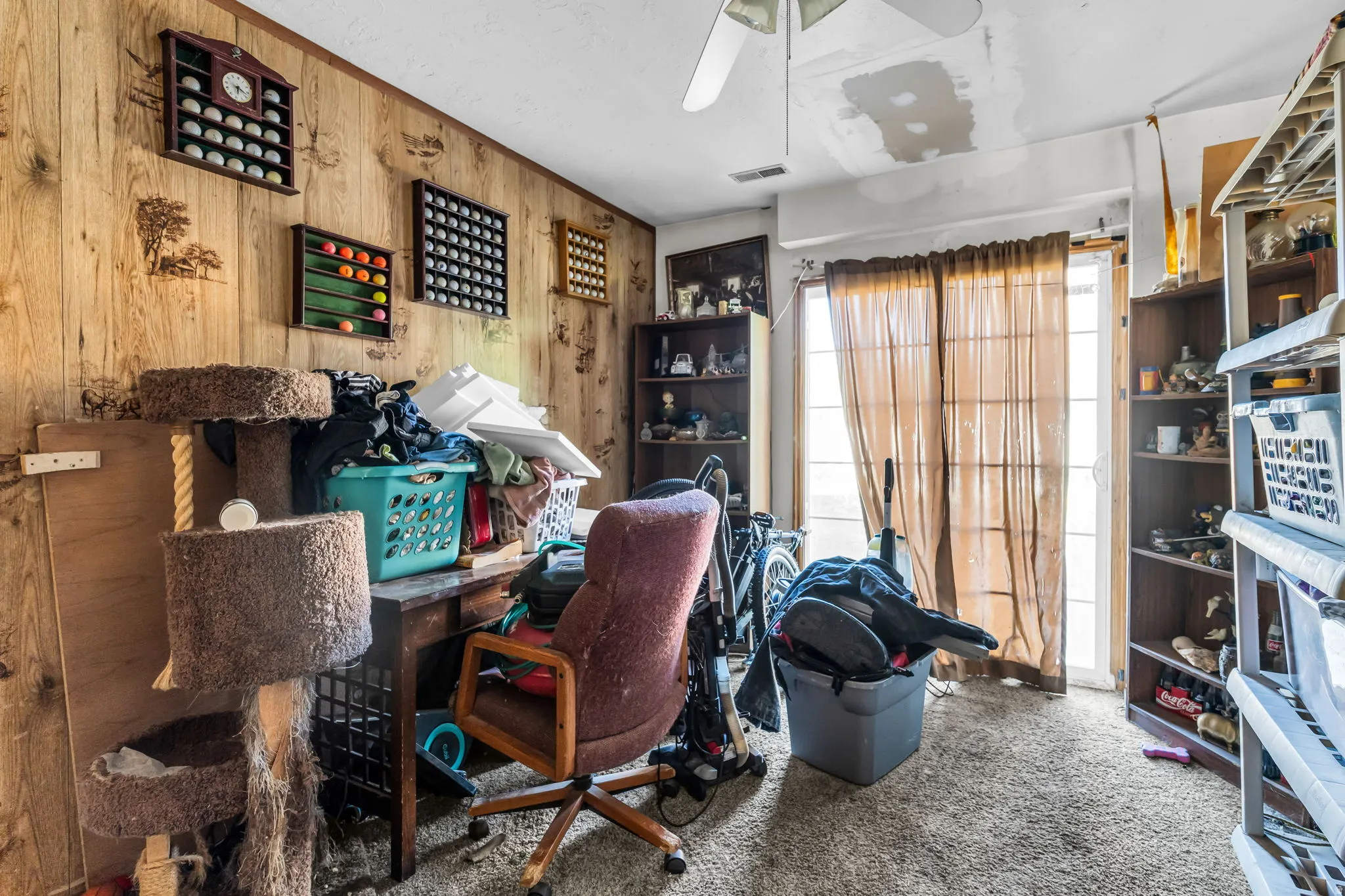Wood-finish paneling walls and carpeted flooring define this room