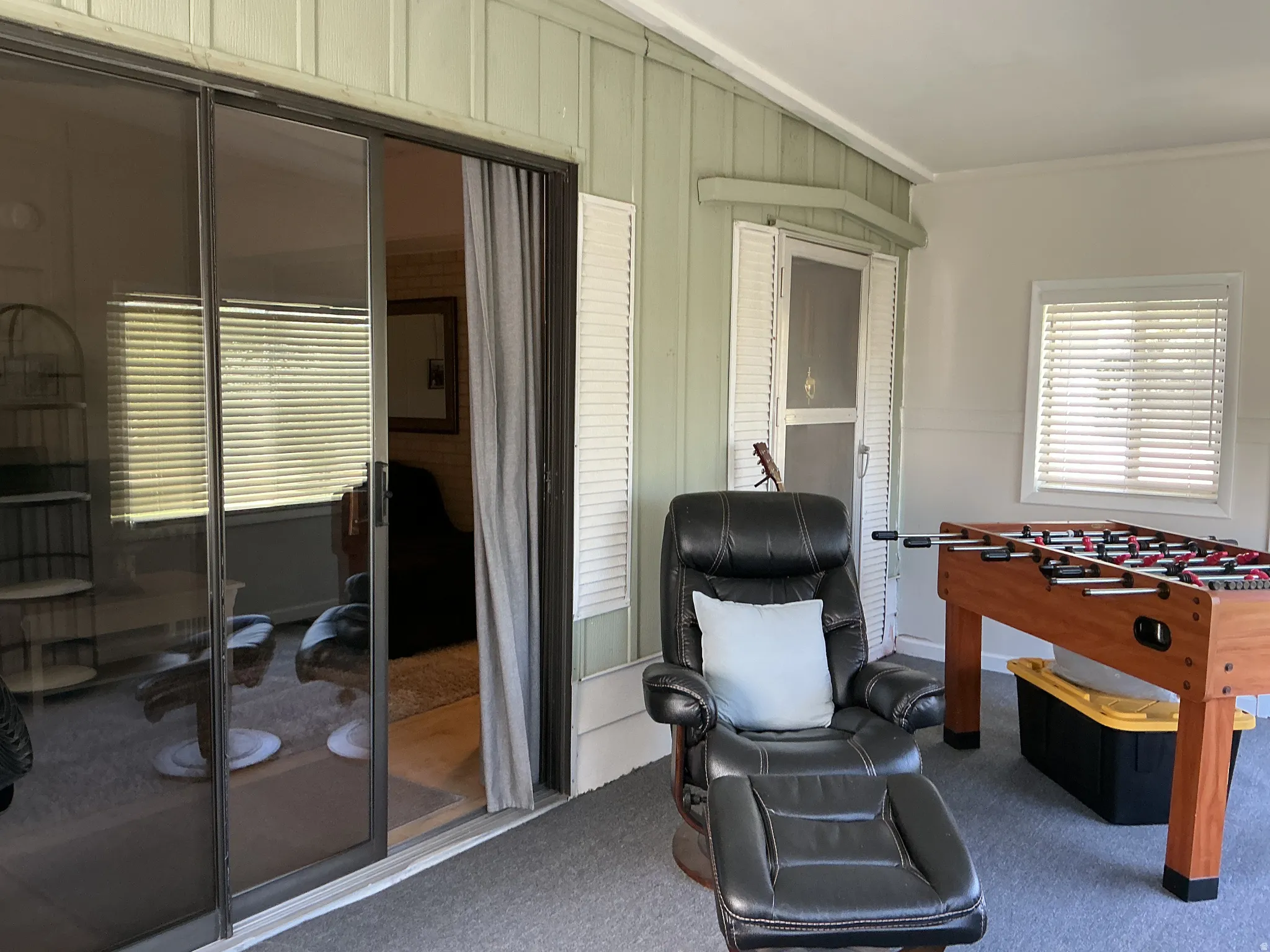 Enclosed patio with sliding glass door entry and screened door