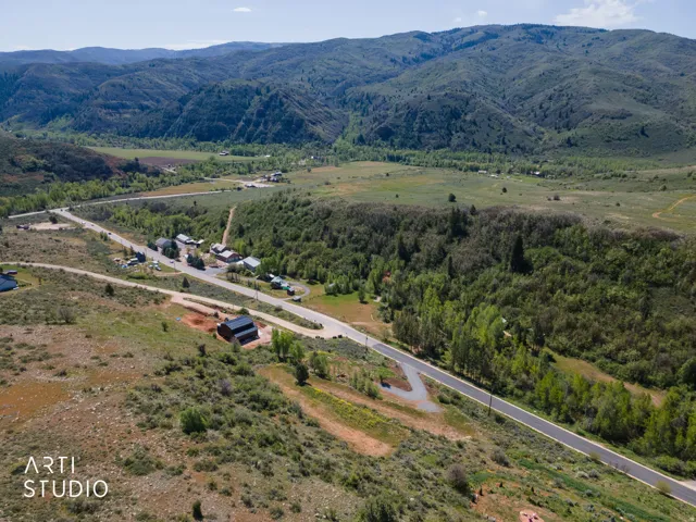 Aerial perspective showcasing a verdant landscape with rolling hills and distant mountains