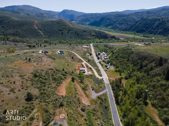 Expansive land parcels framed by rolling hills and distant mountains