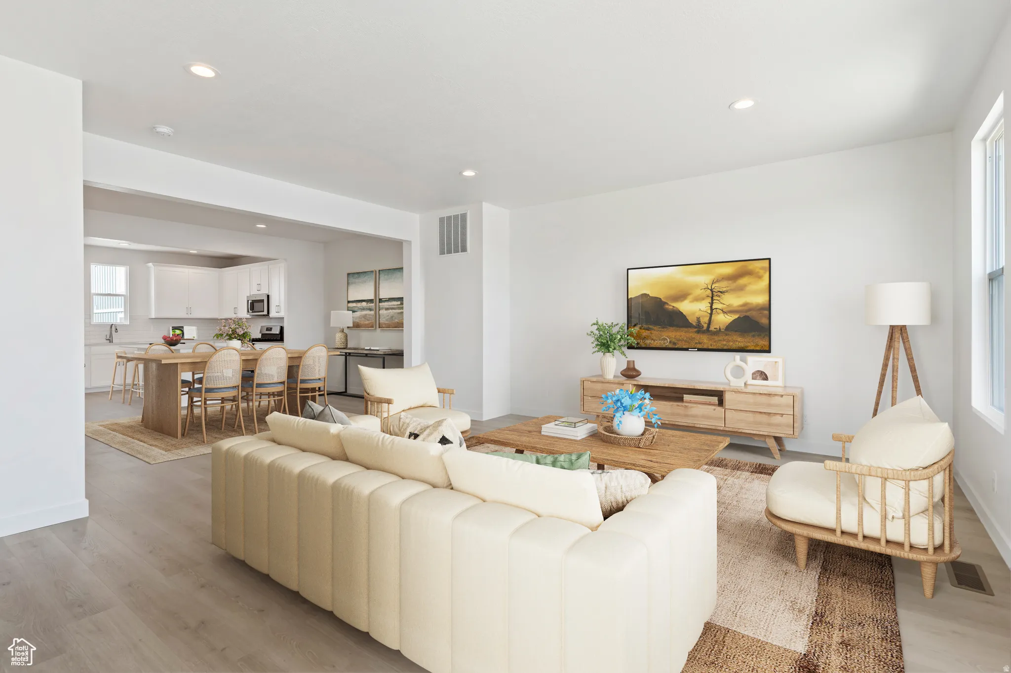 Open-concept living space featuring wood-finish flooring and recessed lighting