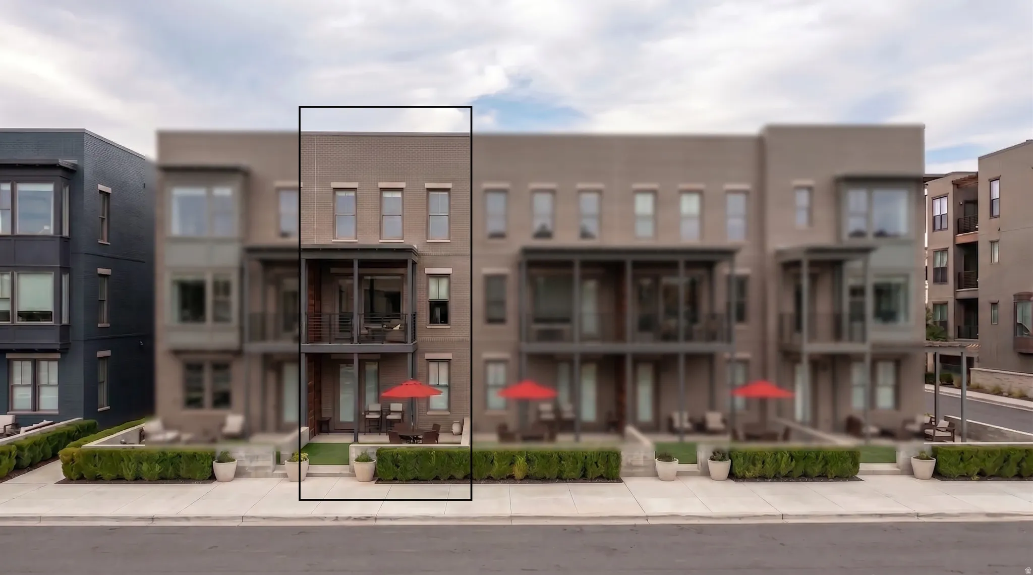 Three-story townhome with a brick facade