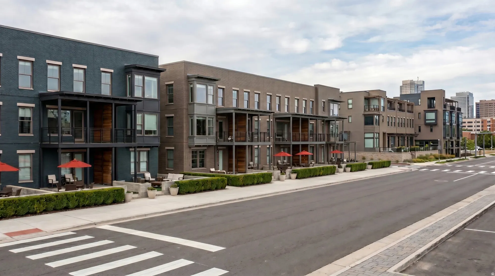 Modern multi-story townhomes featuring brick and paneling facades