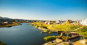 Waterfront community featuring a winding waterway, green spaces, walking paths, and a private dock