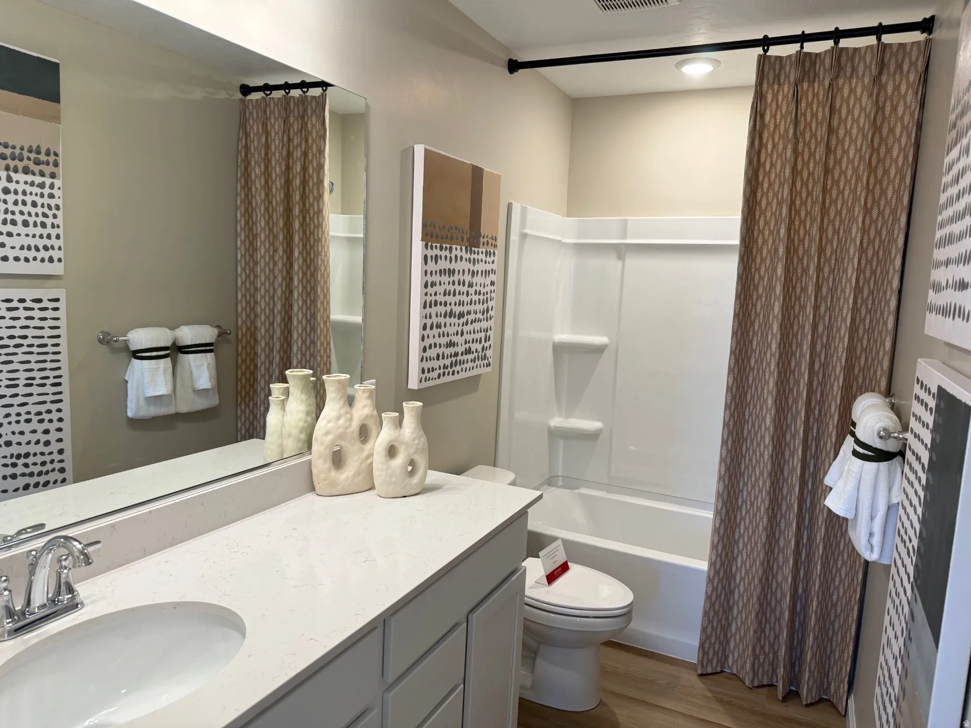 Bathroom featuring a light wood-finish floor and a white vanity with a light-toned countertop