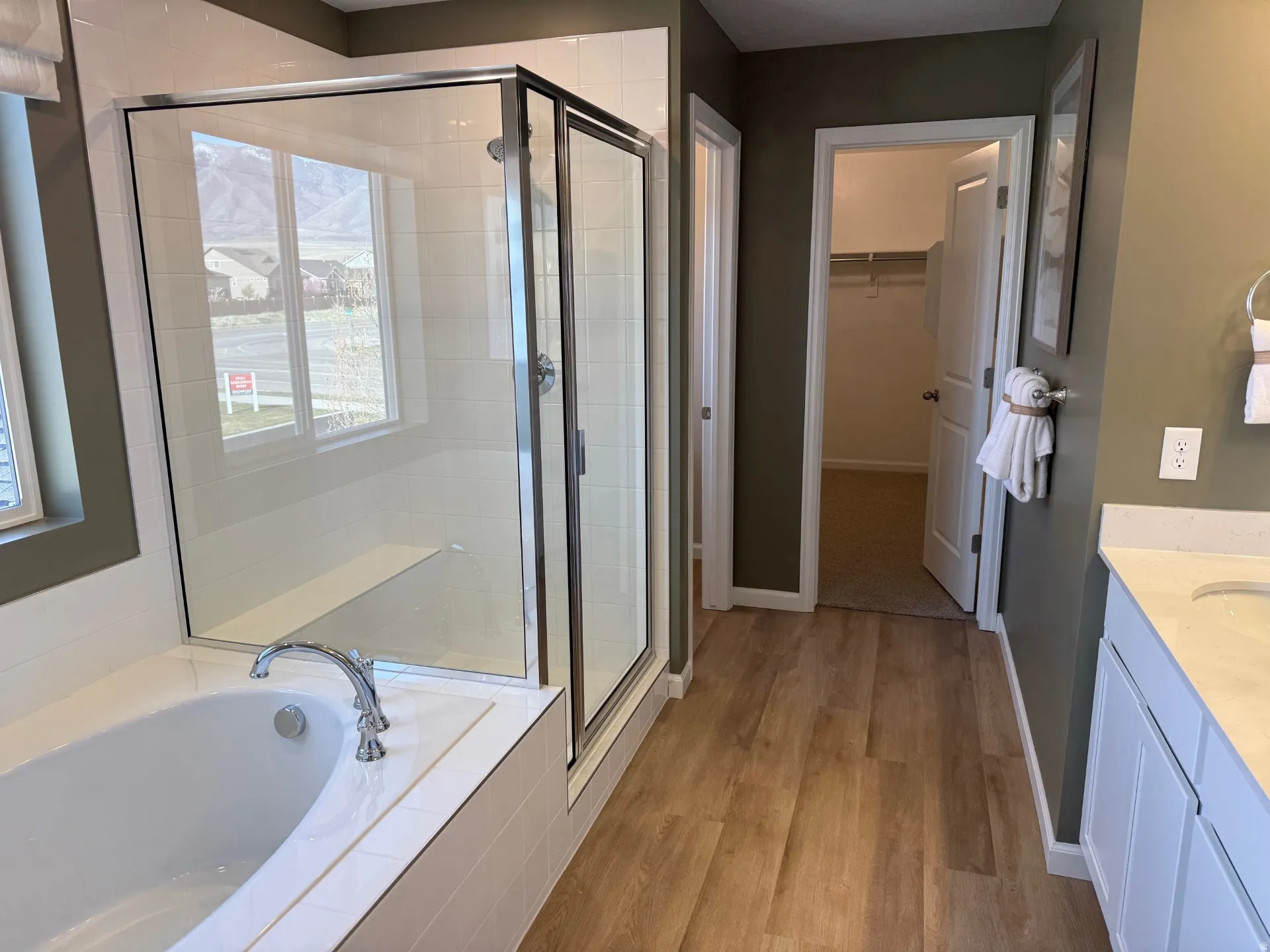 Primary Ensuite Bath. Soaking tub and glass-enclosed shower with a built-in bench
