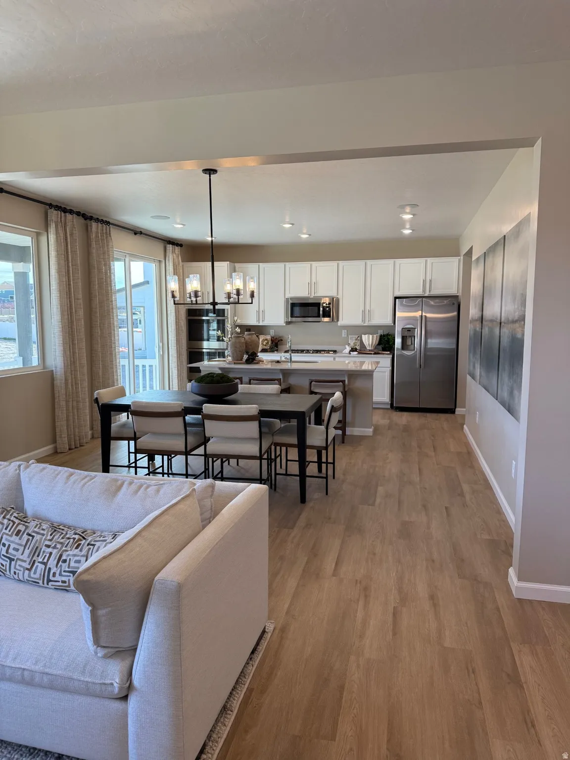 Open-concept living space with wood-finish flooring