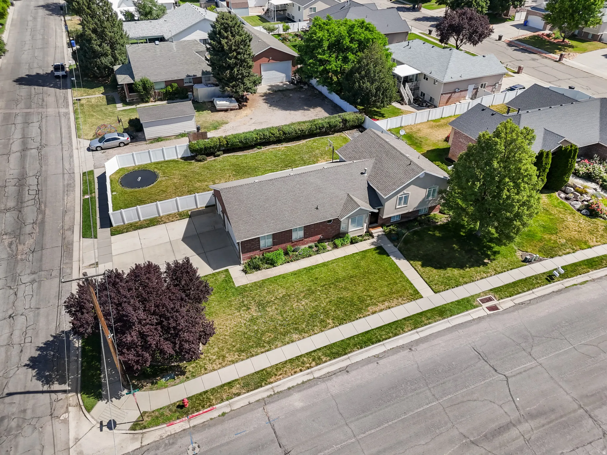 Single-family residence featuring a brick and siding exterior, a well-maintained lawn, and a paved driveway leading to a two-car garage