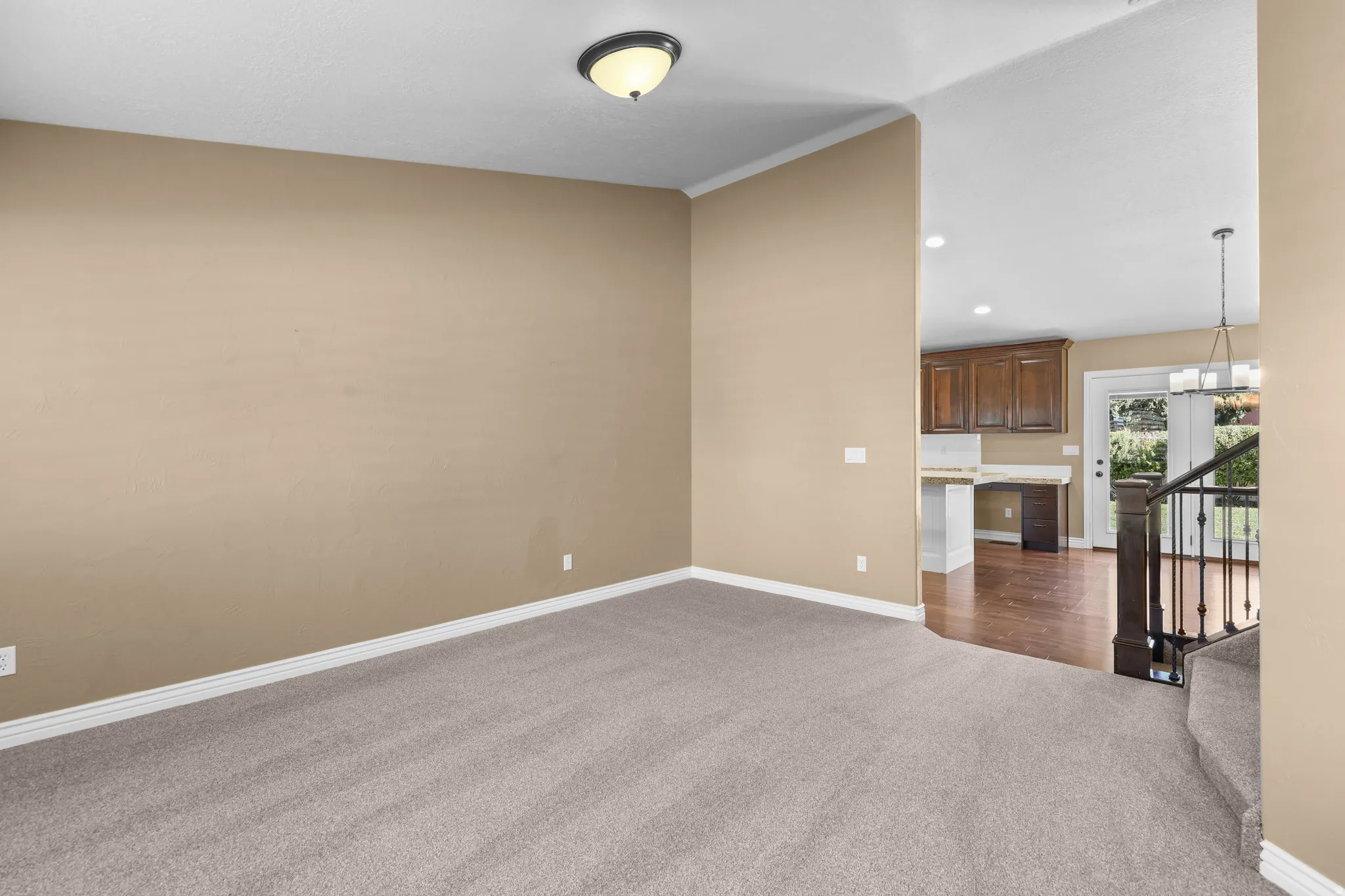 Carpeted room with crown molding, featuring a flush mount ceiling light