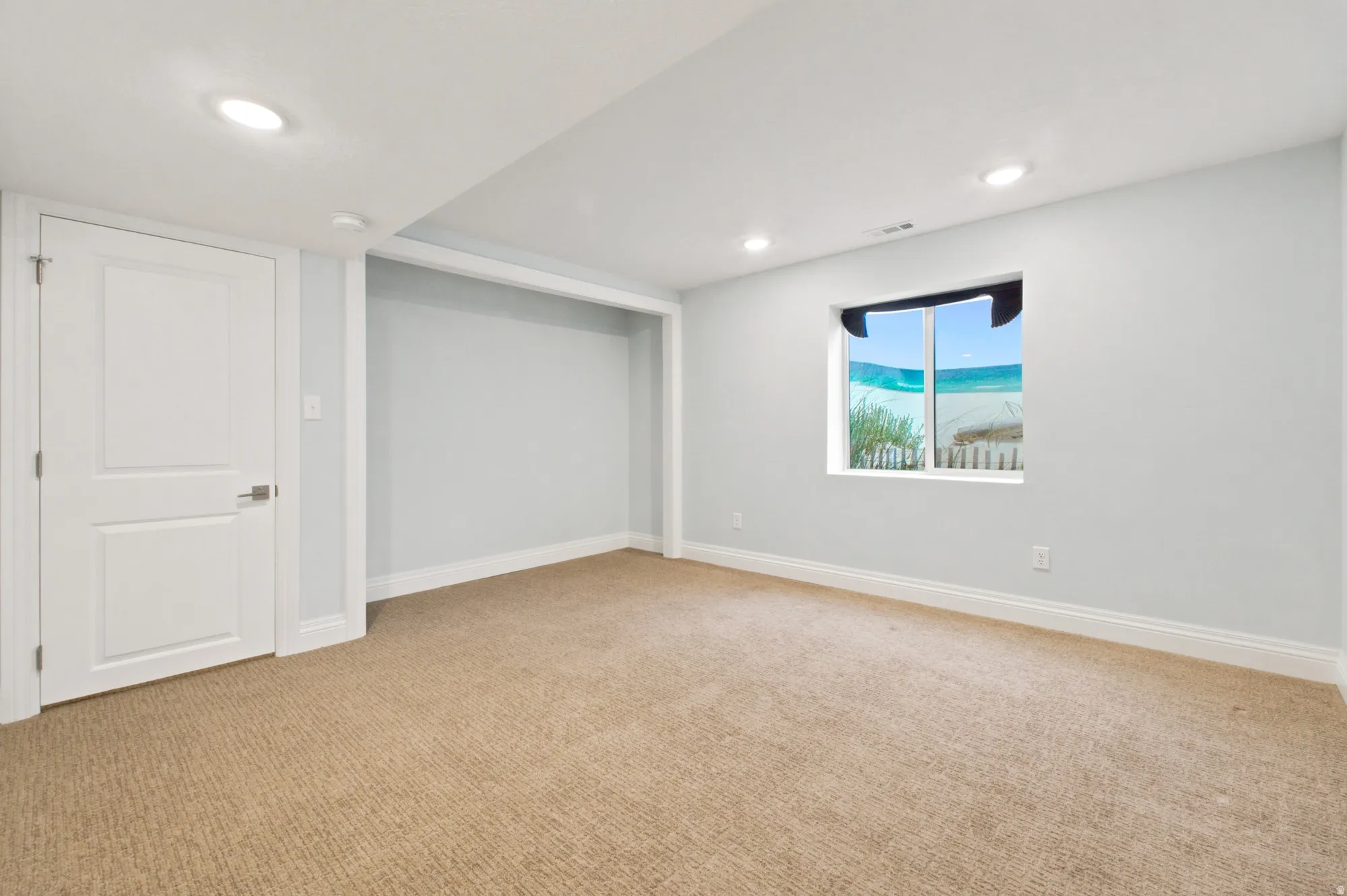 Light-colored carpeting complementing soft wall tones