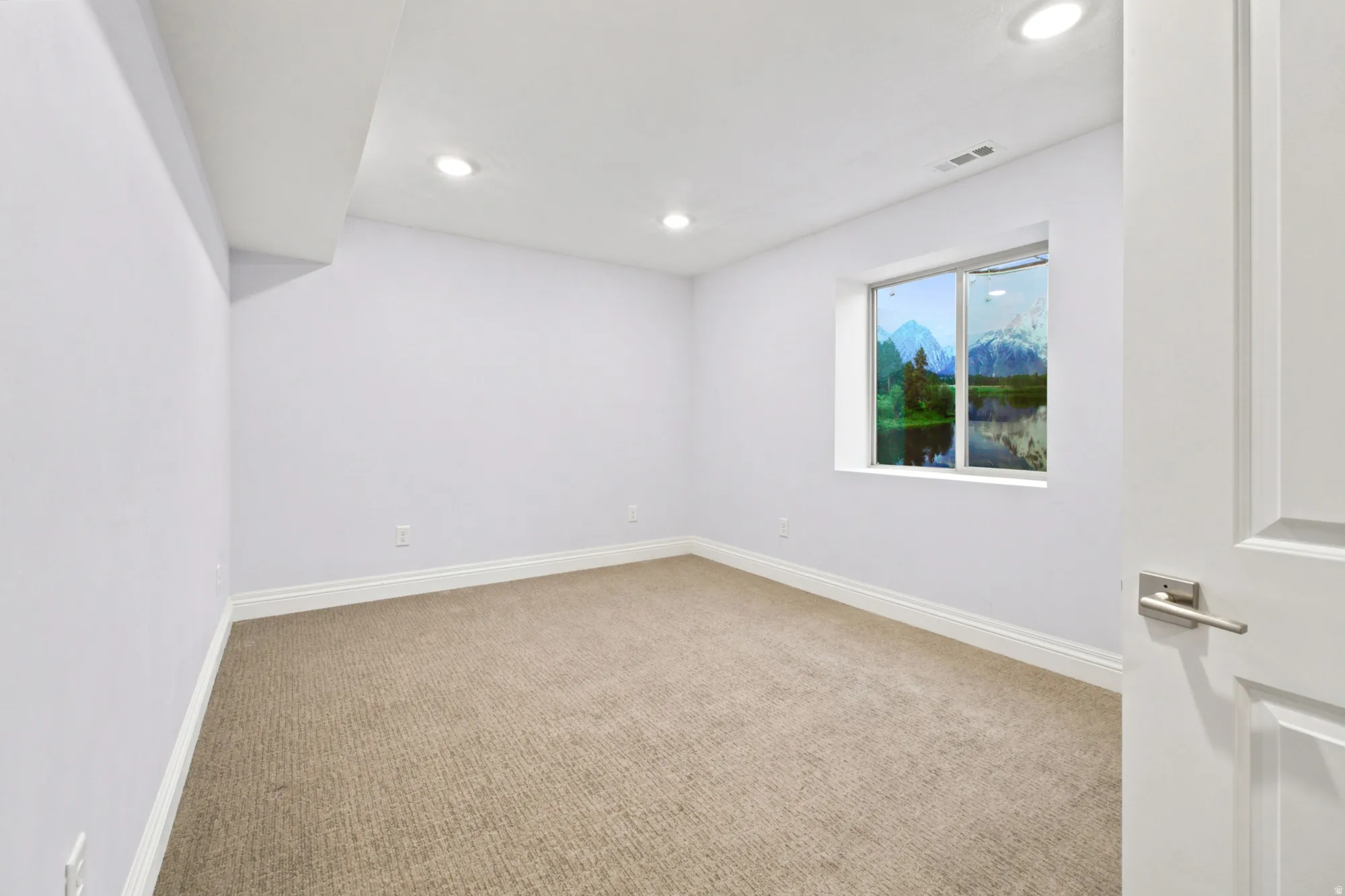 Room featuring light-toned carpeting, white baseboards, and recessed ceiling lighting