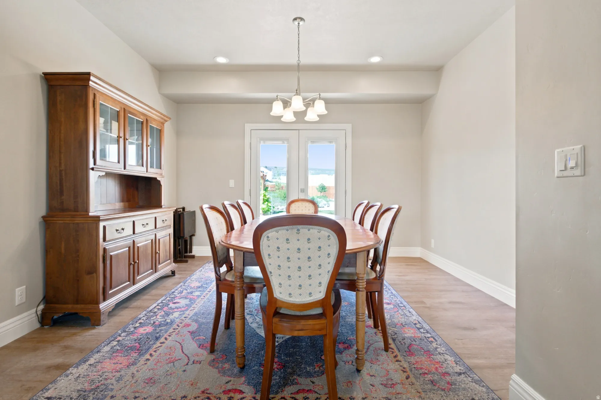 Dining area featuring wood-finish flooring, neutral wall paint, and white baseboards