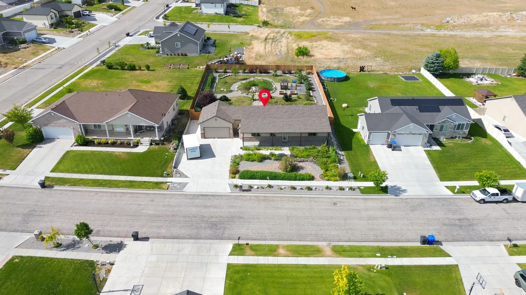 Single-story residence featuring a brown shingle roof, attached two-car garage, and a concrete driveway