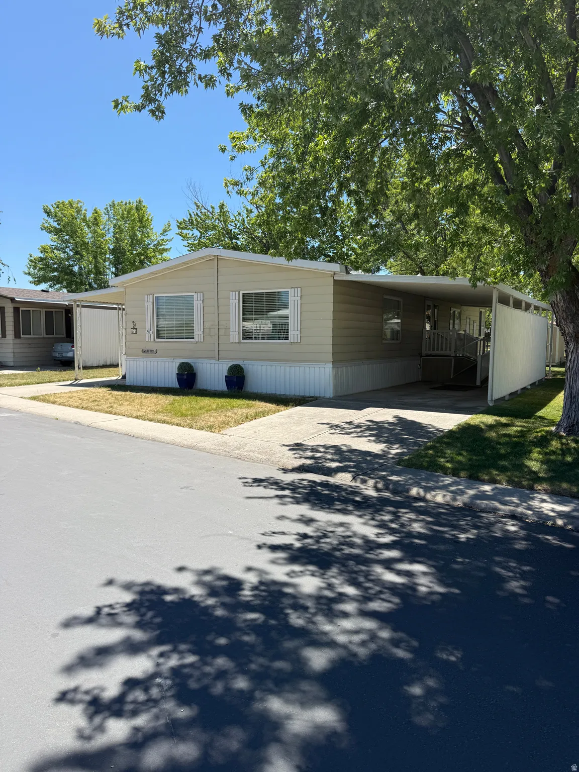Single-story residence featuring light-colored siding and white trim