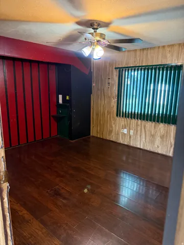 Dark wood-finish flooring extending throughout the space