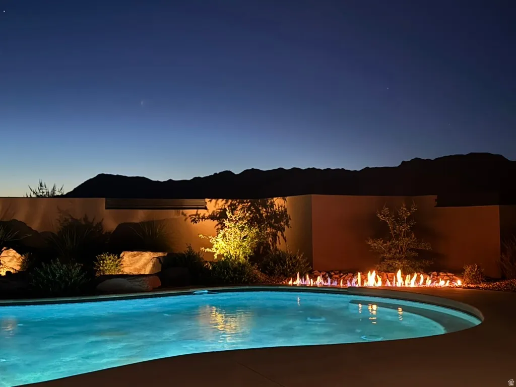 Resort-style pool with a curved fire feature