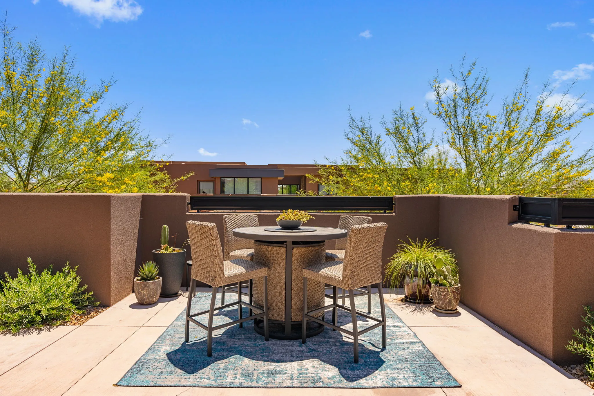Outdoor patio space with stucco walls and concrete flooring