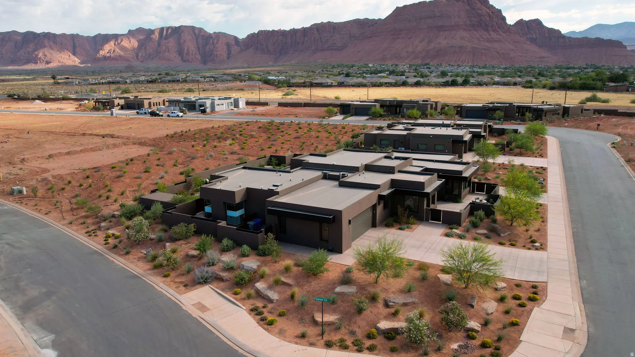 Corner lot, contemporary architectural design featuring a flat roofline and integrated garage