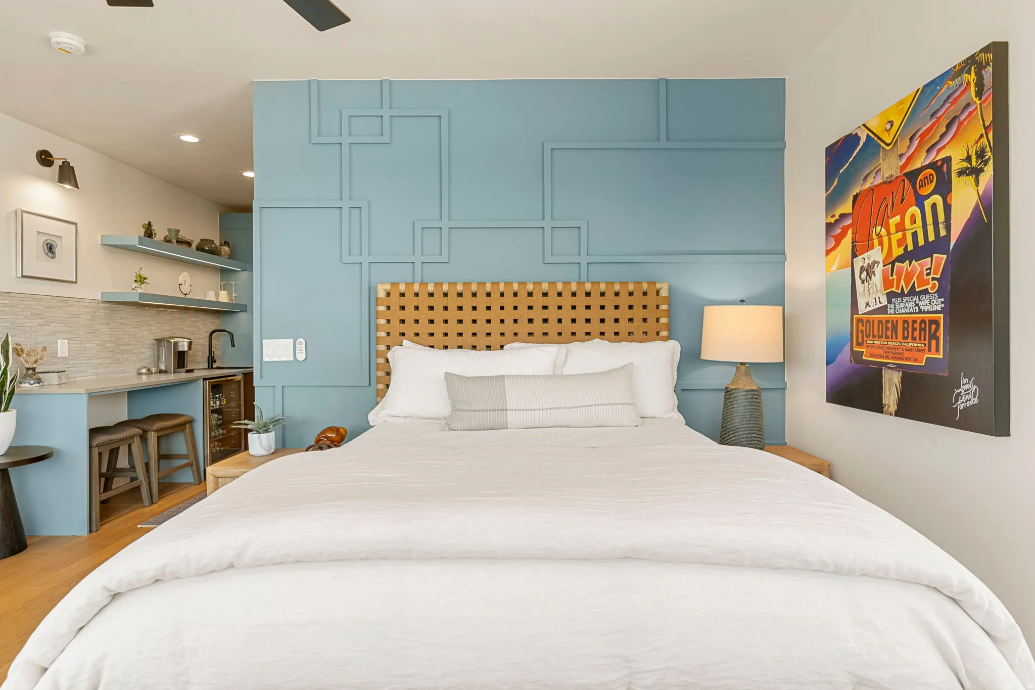 Casita featuring custom accent wall, wood-finish flooring and a ceiling fan