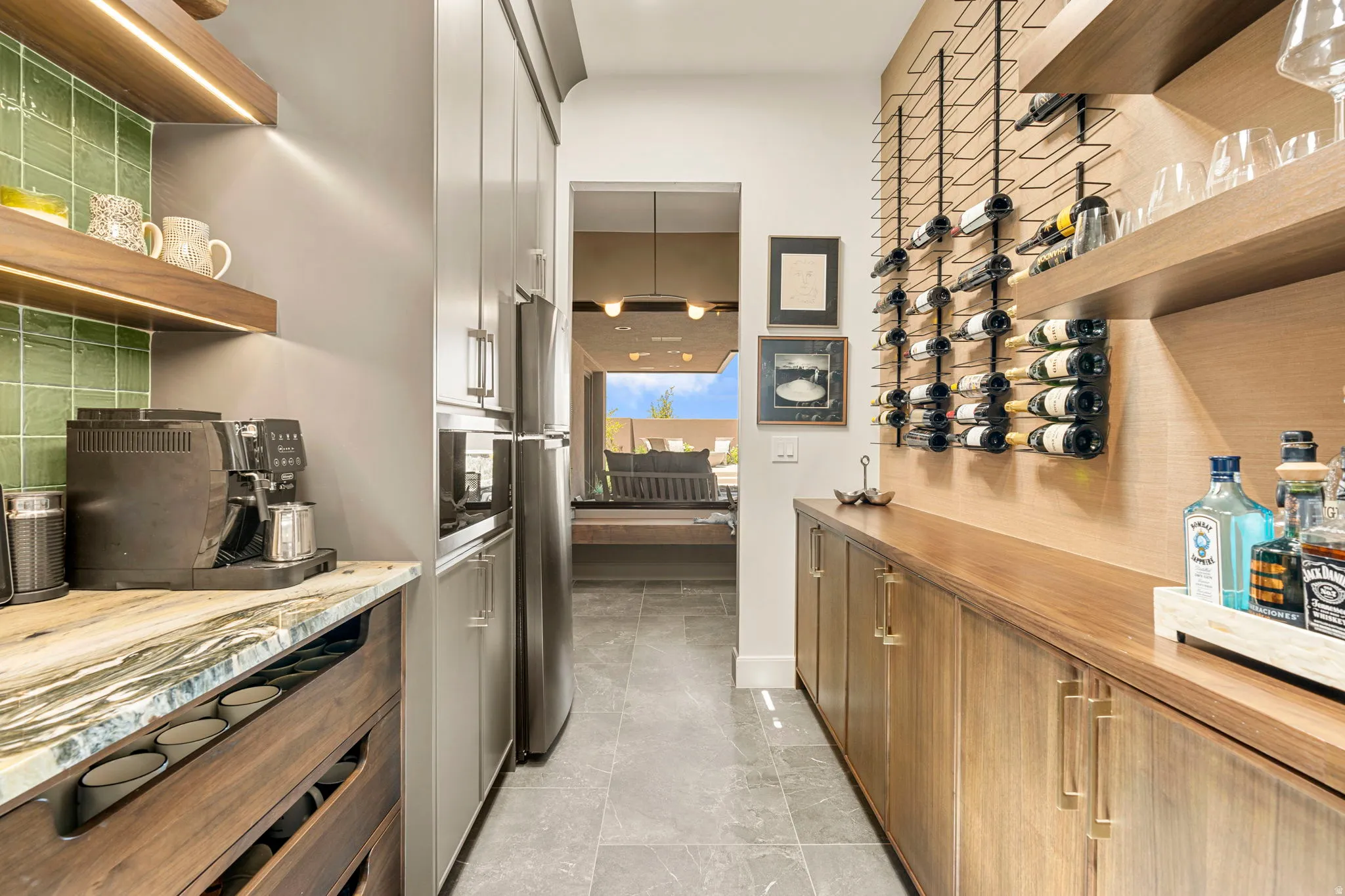 Galley pantry featuring a  quartzite countertop and full tile backsplash