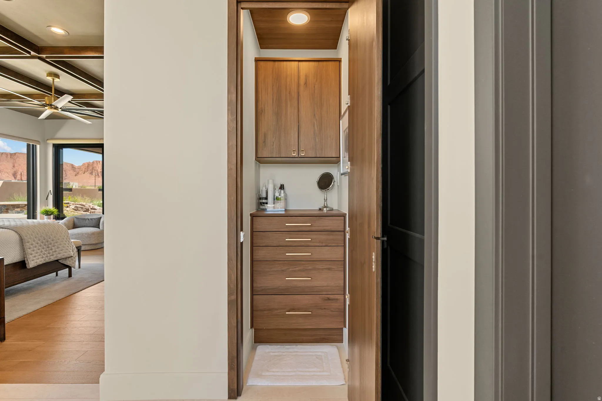 Owner's Suite bathroom hidden closet behind full length mirror containing jewelry cabinet.