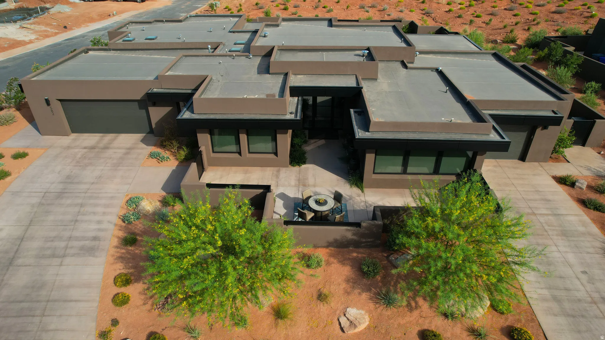 Modern architecture featuring multiple driveways/garages, a multi-level flat roofline and integrated garage