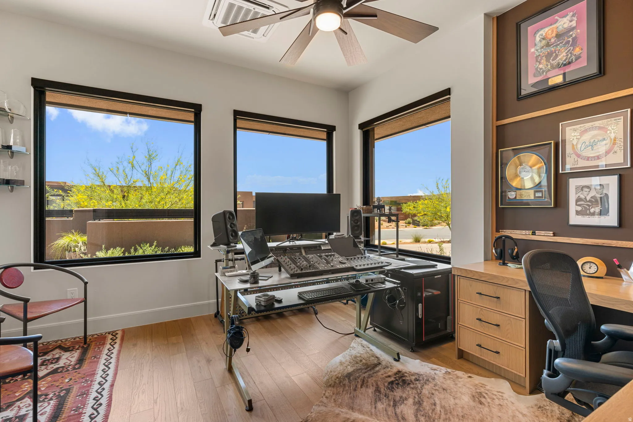 Fourth bedroom or office space featuring hardwood flooring and a custom built-in wood desk with drawers