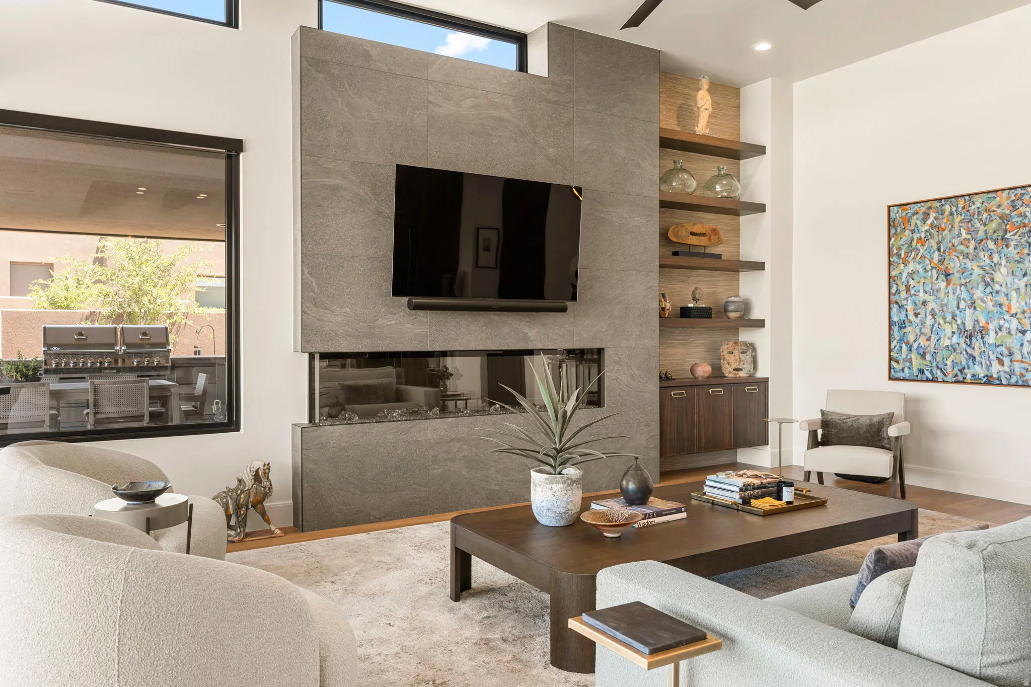 Living area featuring a floor-to-ceiling tile fireplace and media wall