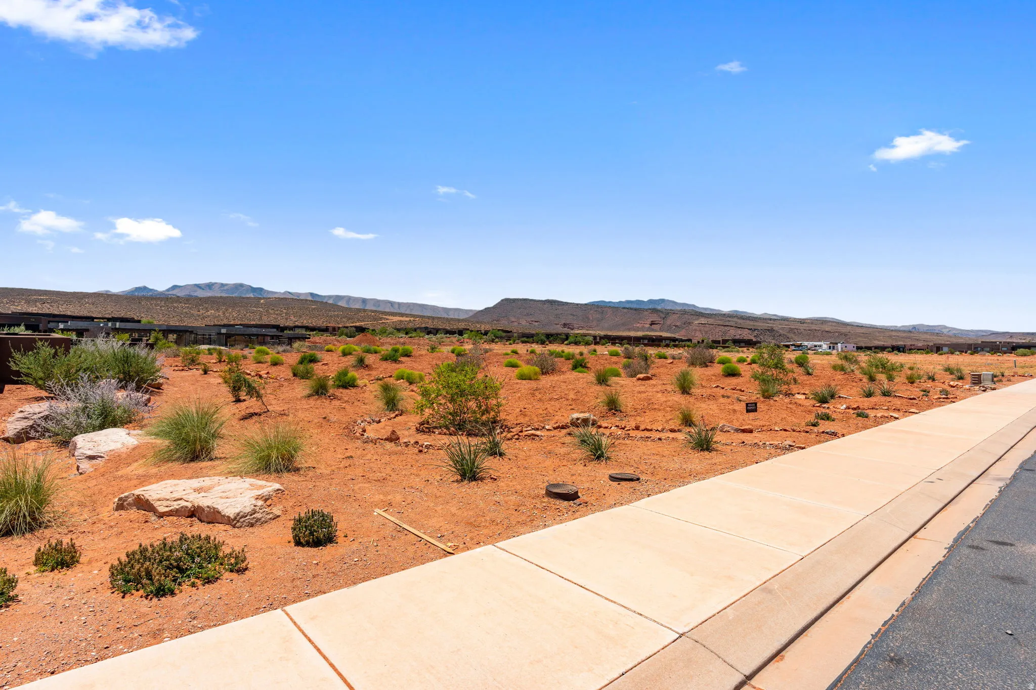 Expansive desert terrain on view protection lot featuring natural rock formations and low-lying vegetation