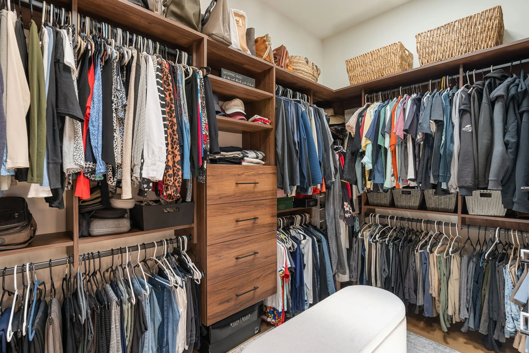 Custom closet system featuring wood-finish shelving and built-in drawers