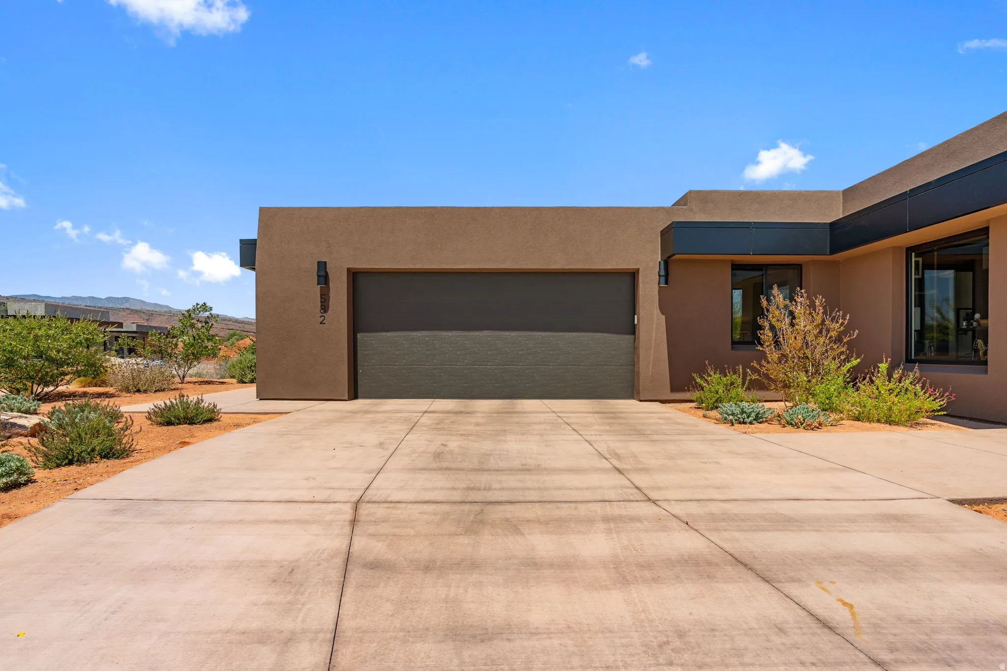 Concrete driveway leading to a multi-car garage.
