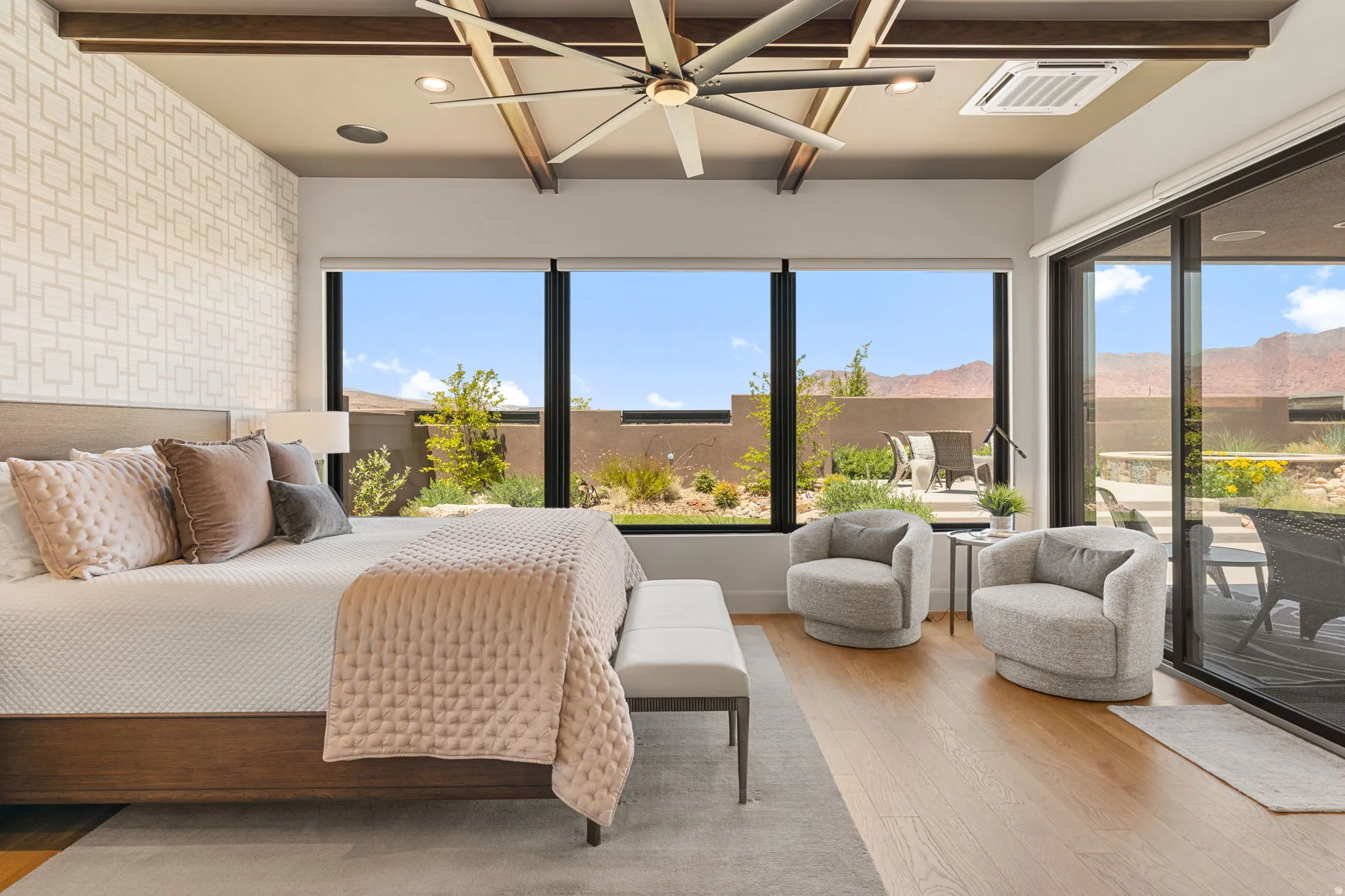 Expansive Owner's Suite featuring massive windows, hardwood flooring, and a sliding glass door to the exterior