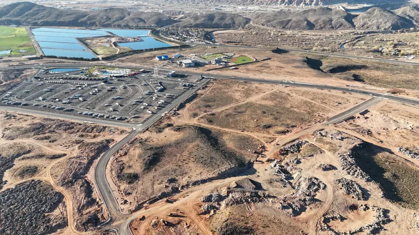 Expansive desert landscape featuring undeveloped terrain with visible infrastructure for future development
