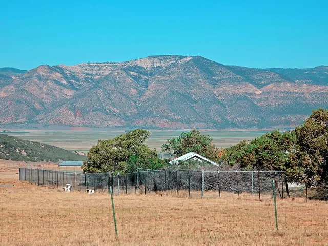 Expansive natural landscape with a distant mountain range and open fields