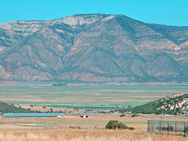 Expansive mountain range backdrop framing a broad valley with varied terrain