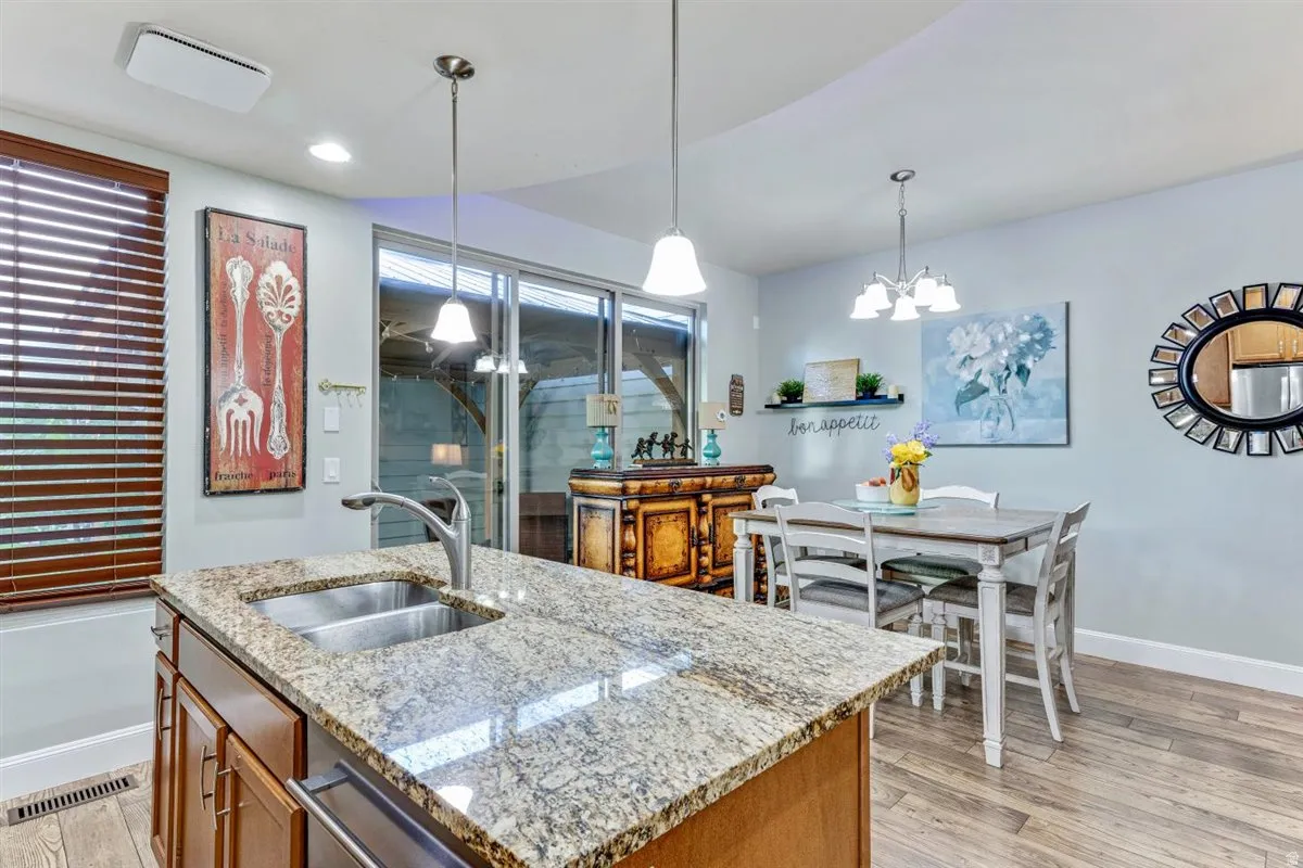 Kitchen island with granite countertop and undermount double-basin stainless steel sink
