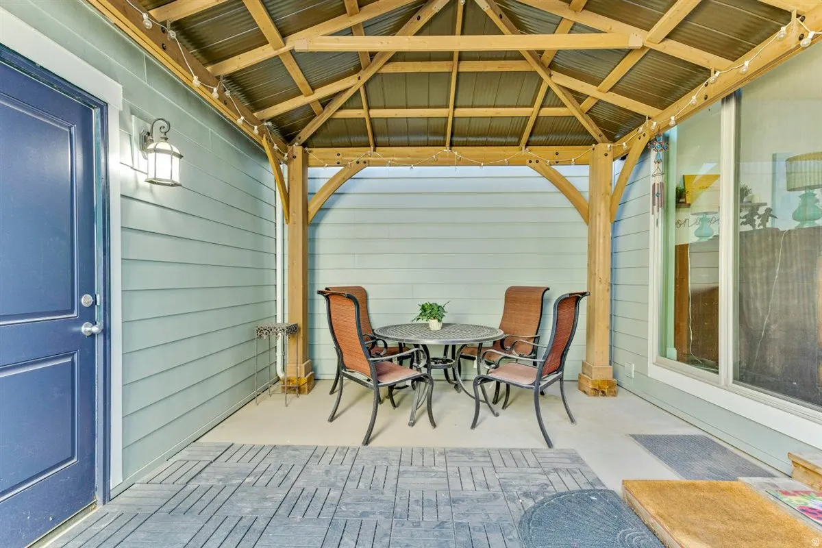 Covered patio featuring a wood-beam gazebo with a metal roof