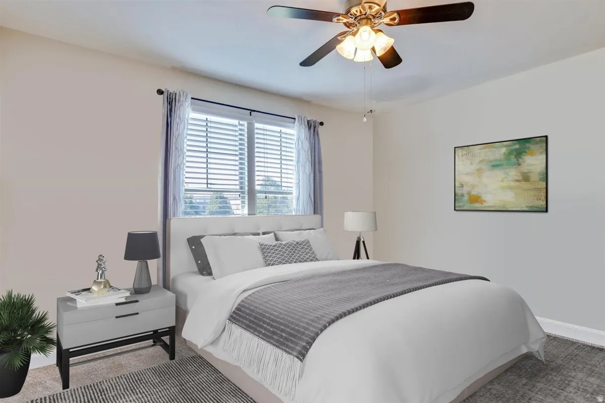 Bedroom featuring a ceiling fan with integrated lighting, window with horizontal blinds, and a neutral color palette