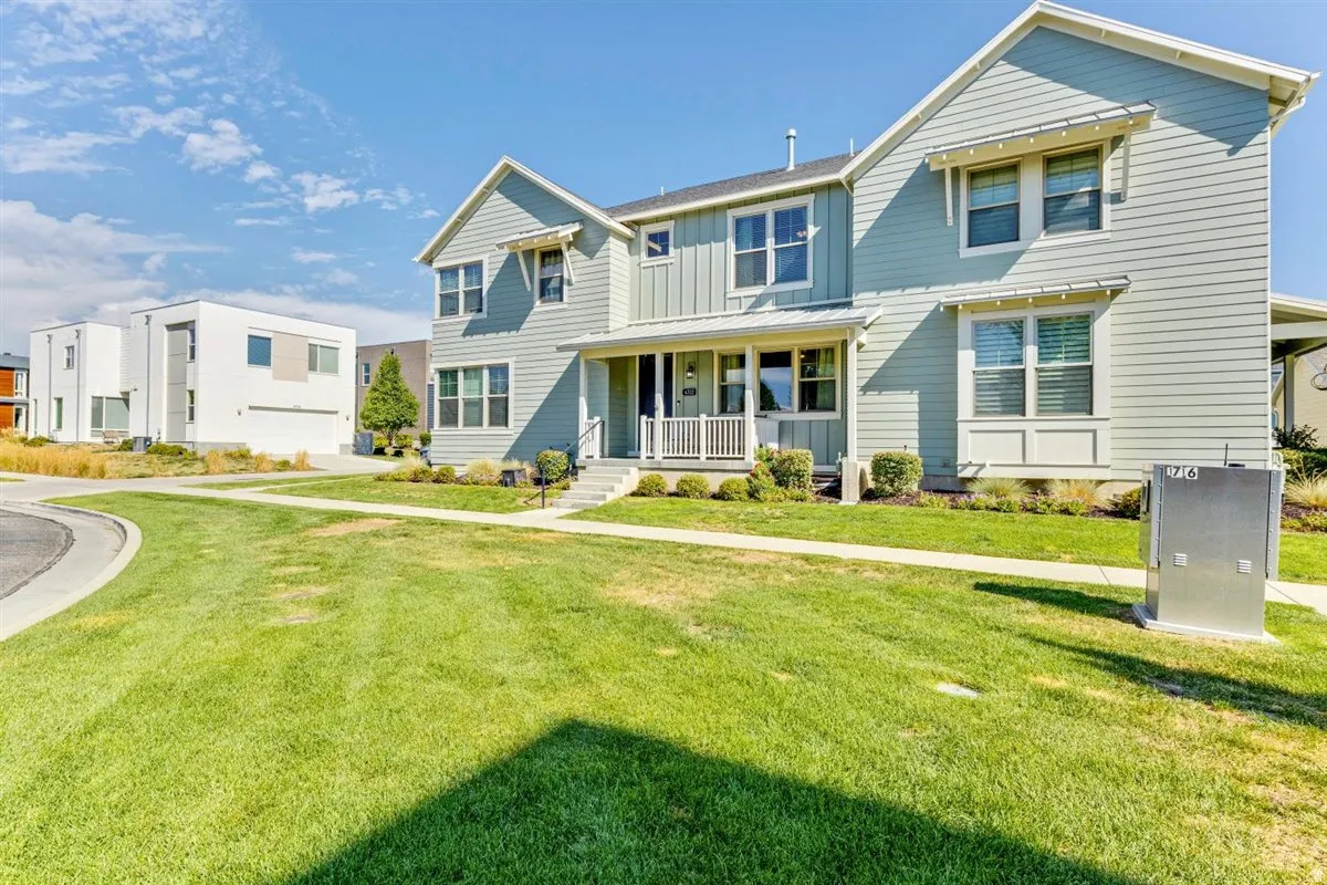 Two-story residence featuring light blue horizontal siding with white trim accents