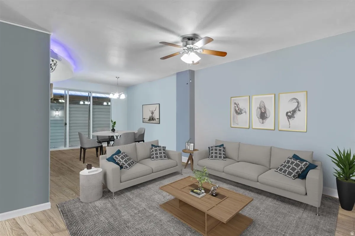 Open-concept living space featuring wood-finish flooring, recessed lighting, and a ceiling fan with light kit