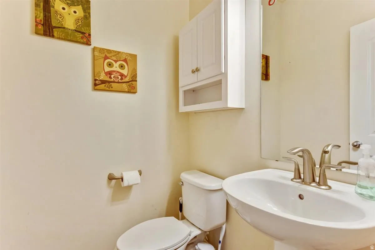 Pedestal sink with a brushed nickel faucet