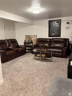 Neutral-toned, textured carpeting spans the room, complemented by white baseboards
