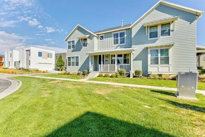 Two-story residence featuring light blue horizontal siding with white trim accents