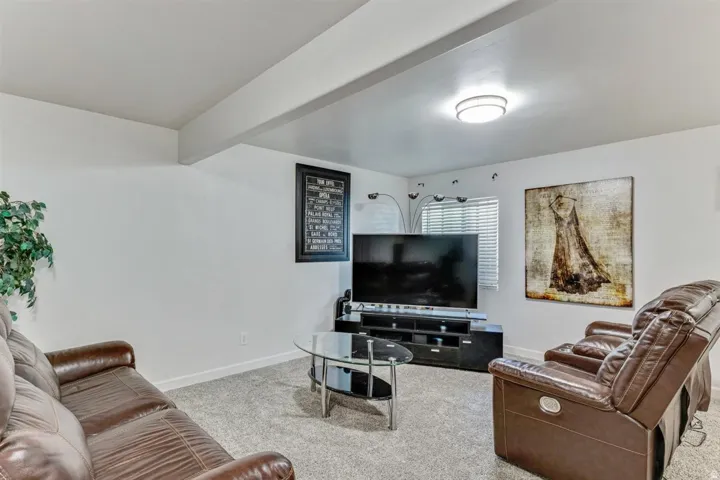 Finished lower-level space featuring light gray carpeting and white walls