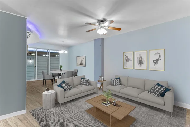 Open concept living area with light blue walls, wood-finish flooring, recessed lighting, and a ceiling fan
